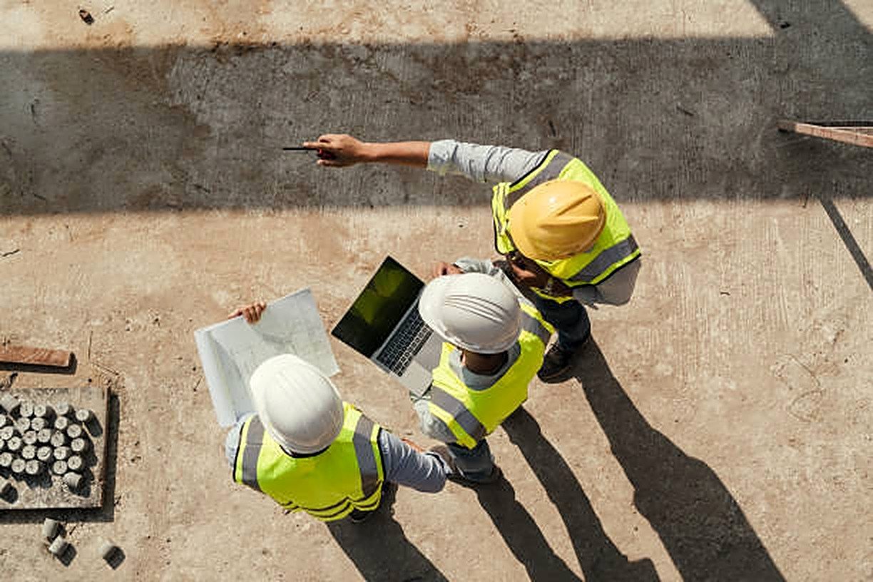 Site team reviewing plans on an active job