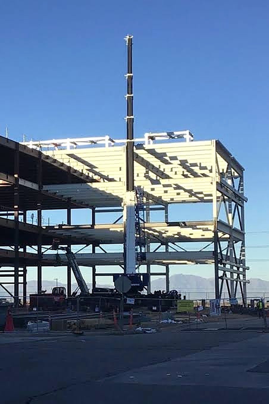 Multi-level steel frame going up with a crane